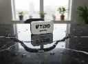 Nano ceramic applicator pad sitting on a black reflective surface with water beads.